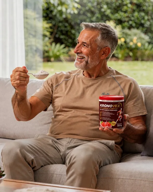 Homem tomando a dose de KRONOVEX no sofá